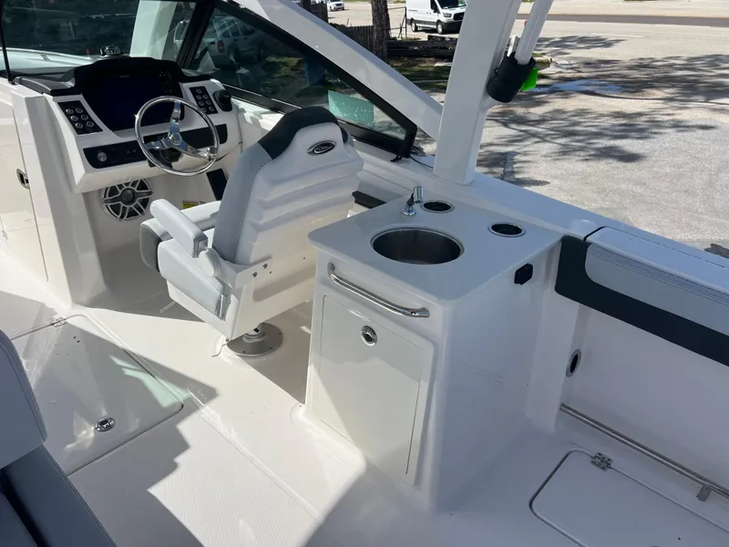 Slide: The Image of 2025 Robalo R257 Dual Console boat interior with helm, seating, and sink station. - 10