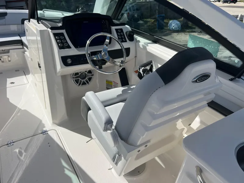 Slide: The Image of 2025 Robalo R257 Dual Console boat interior with steering wheel and control panel. - 11