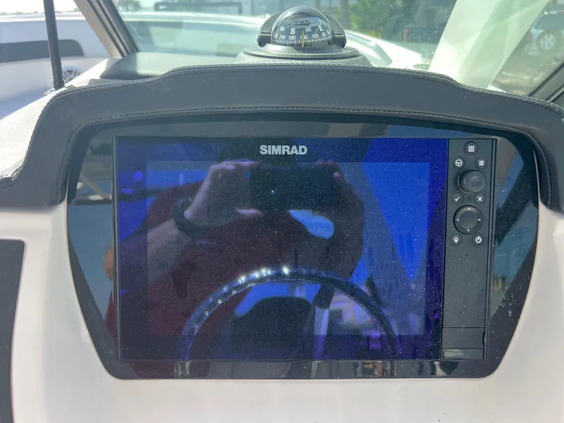 Slide: The Image of Simrad display and compass on 2025 Robalo R257 Dual Console boat dashboard. - 13