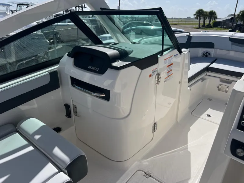 Slide: The Image of 2025 Robalo R257 Dual Console boat interior with seating and storage compartments. - 14