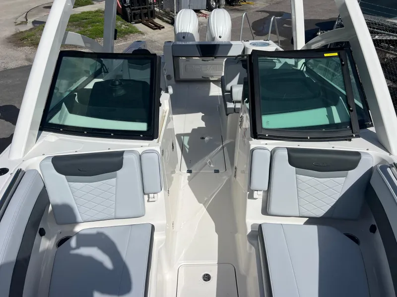Slide: The Image of 2025 Robalo R257 Dual Console boat interior with seating and windshield. - 19