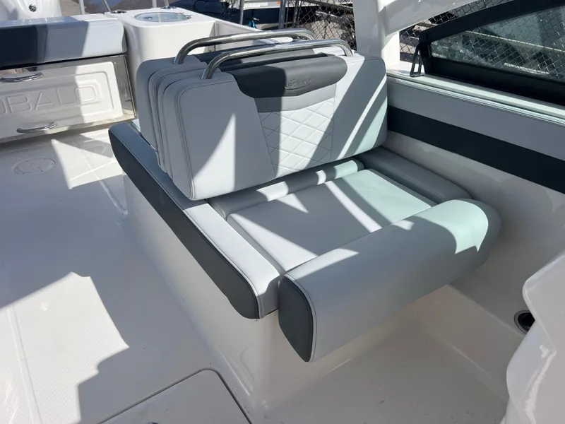 Slide: The Image of 2025 Robalo R257 Dual Console boat seat with elegant gray upholstery and modern design. - 21