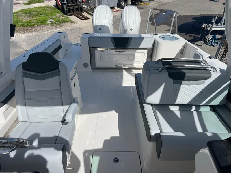 Slide: The Image of 2025 Robalo R257 Dual Console boat interior with seating and storage compartments. - 22