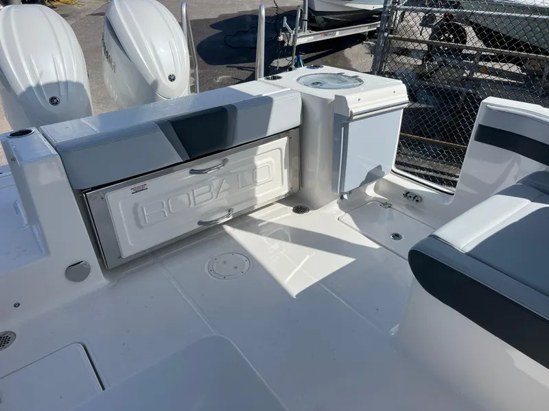 Slide: The Image of 2025 Robalo R257 Dual Console boat interior with seating and storage compartments. - 23