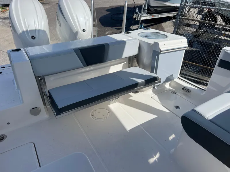 Slide: The Image of 2025 Robalo R257 Dual Console boat interior with seating and dual engines. - 24