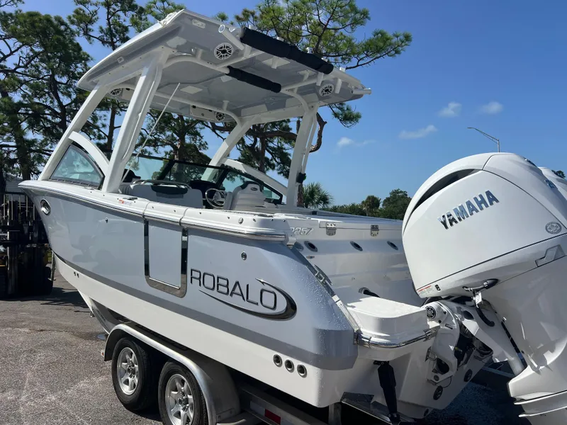 Slide: The Image of 2025 Robalo R257 Dual Console boat with Yamaha engine on trailer. - 3