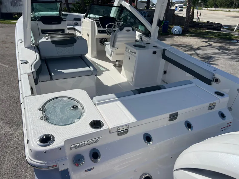Slide: The Image of 2025 Robalo R257 Dual Console boat interior with seating and helm. - 6