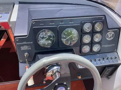 Slide: The Image of Dashboard of a 1988 Donzi R23 boat with gauges and steering wheel. - 4