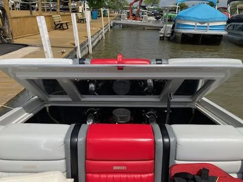 Slide: The Image of 1988 Donzi R23 boat engine compartment open at a dockside marina. - 5