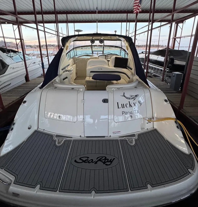 The Image of 2007 Sea Ray 38 Sundancer yacht cruising on a sunny day near the shoreline. - 0