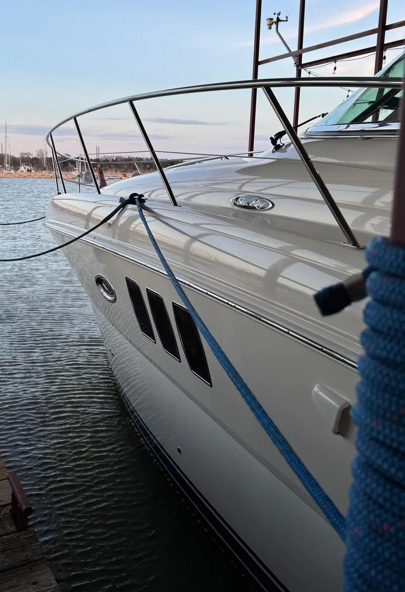 Slide: The Image of 2007 Sea Ray 38 Sundancer yacht on calm water with American flag. - 13