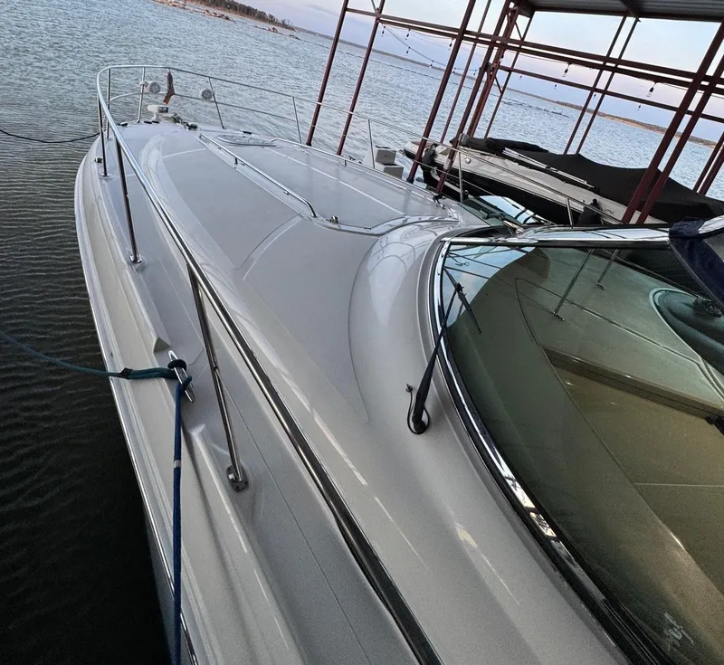 Slide: The Image of 2007 Sea Ray 38 Sundancer yacht on calm water with American flag. - 2