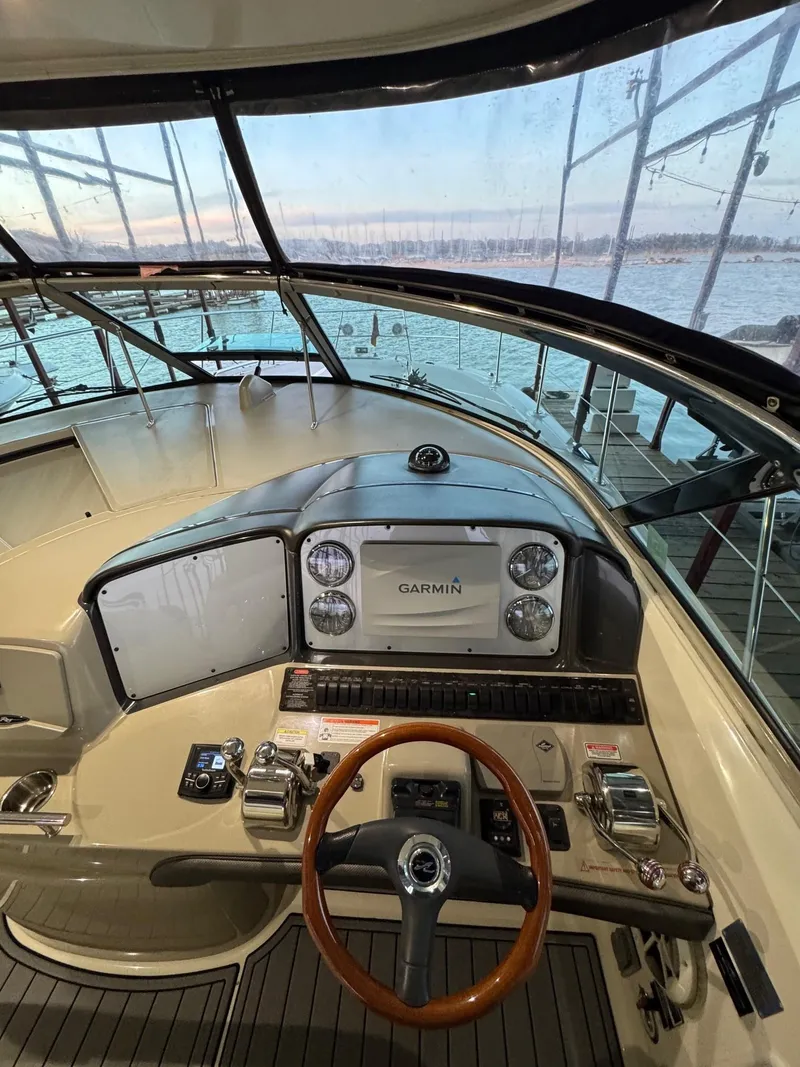 Slide: The Image of 2007 Sea Ray 38 Sundancer helm with Garmin navigation, overlooking marina waters. - 33