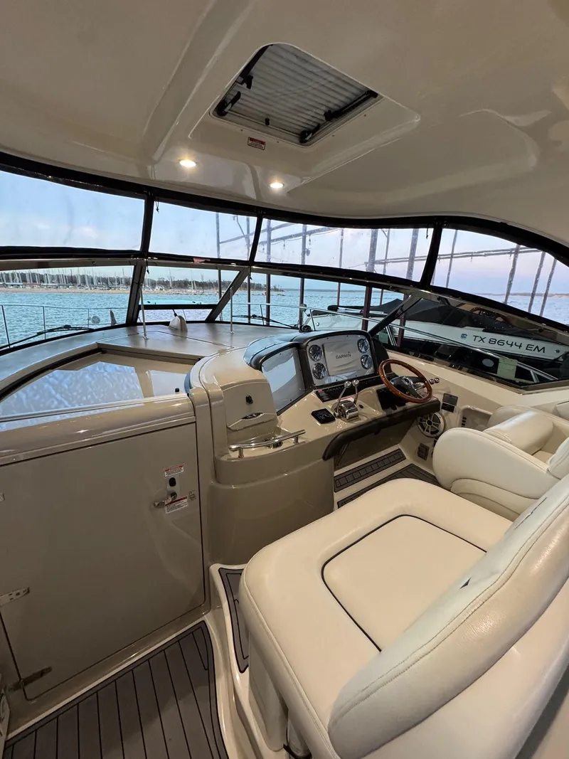 Slide: The Image of 2007 Sea Ray 38 Sundancer helm with luxurious seating and panoramic water views. - 38