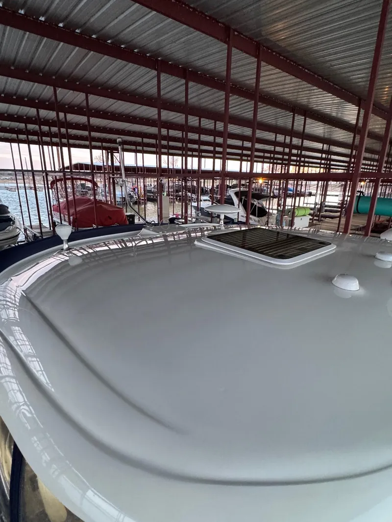 Slide: The Image of 2007 Sea Ray 38 Sundancer boat on water with American flag, rear view. - 5