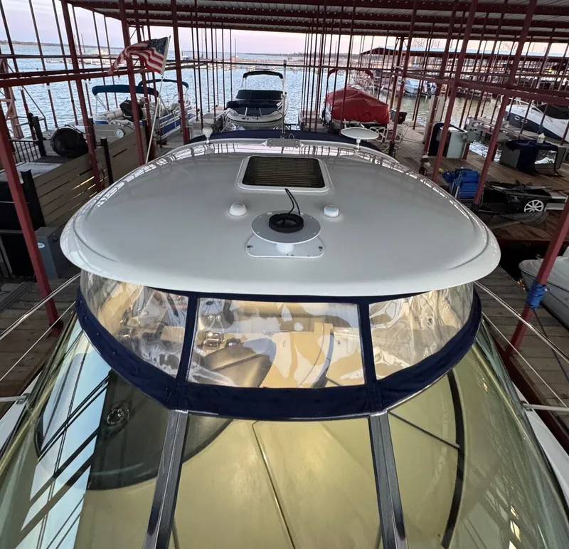 Slide: The Image of 2007 Sea Ray 38 Sundancer boat on water, rear view with American flag. - 7