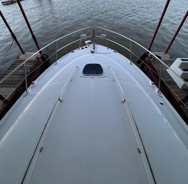 Slide: The Image of 2007 Sea Ray 38 Sundancer yacht on calm water, American flag waving. - 8