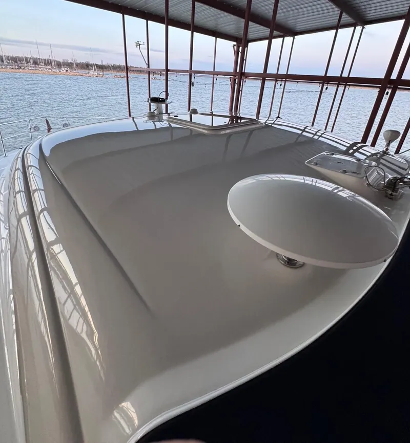 Slide: The Image of 2007 Sea Ray 38 Sundancer yacht on calm water with American flag. - 9