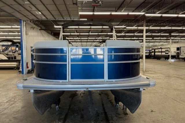 Slide: The Image of 2025 Harris CR190 pontoon boat in a spacious indoor showroom. - 10