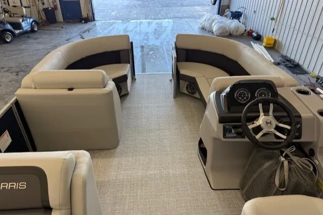 Slide: The Image of Interior of a 2025 Harris CR190 boat with beige seating and modern dashboard. - 12