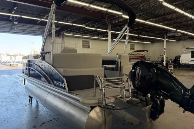 Slide: The Image of 2025 Harris CR190 pontoon boat in a warehouse, featuring a Mercury outboard motor. - 6