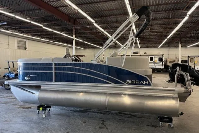 Slide: The Image of 2025 Harris CR190 pontoon boat in a warehouse setting. - 7