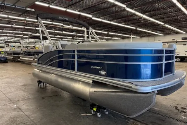 Slide: The Image of 2025 Harris CR190 pontoon boat in a showroom, featuring sleek blue design and modern structure. - 9