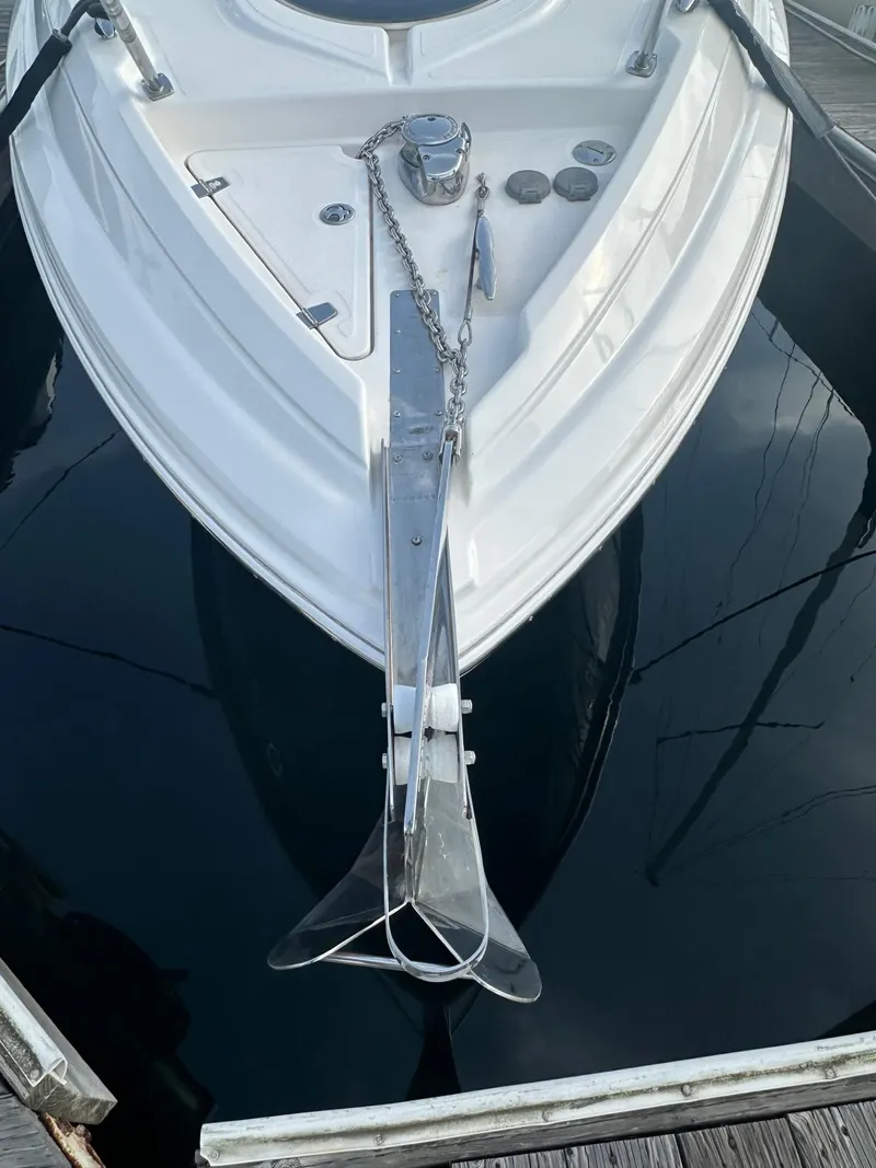 Slide: The Image of 2013 Regal 28 Express boat bow with anchor and chain in marina. - 2