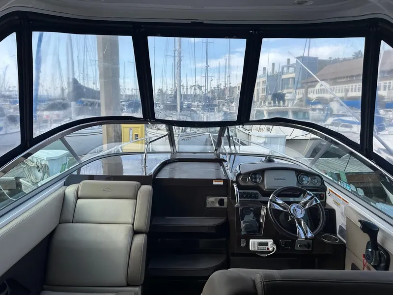 Slide: The Image of Interior view of 2013 Regal 28 Express boat cockpit with steering wheel and dashboard. - 4