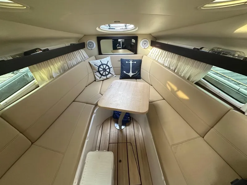 Slide: The Image of Interior of 2013 Regal 28 Express boat with beige seating and nautical decor. - 8