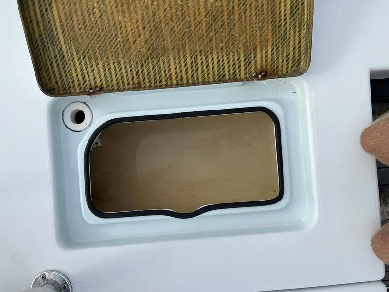 Slide: The Image of Open storage compartment on 2009 Maverick HPX-V boat, featuring a textured lid. - 12