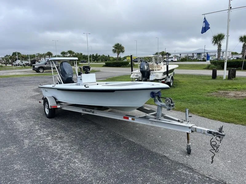 Slide: The Image of 2009 Maverick HPX-V boat on trailer in parking lot, overcast sky. - 2