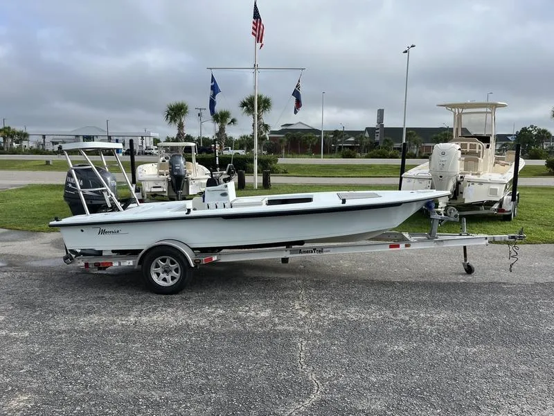 Slide: The Image of 2009 Maverick HPX-V boat on trailer, parked outdoors with flags and palm trees in background. - 4