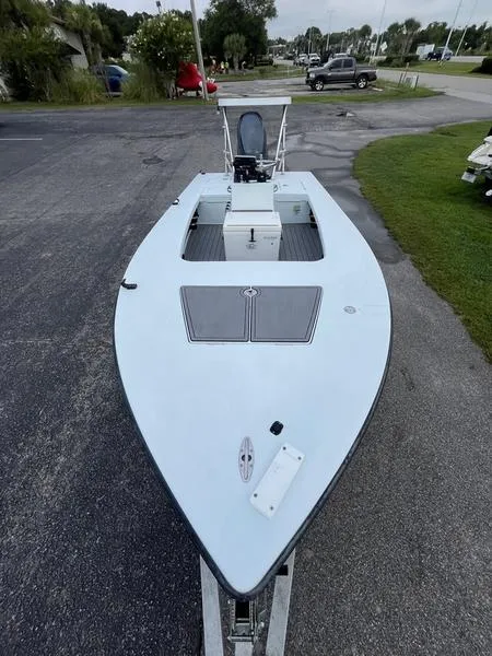 Slide: The Image of 2009 Maverick HPX-V boat on trailer, parked on asphalt near grass. - 6