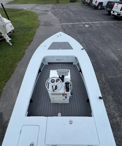 Slide: The Image of 2009 Maverick HPX-V boat with steering console, parked on pavement near grass. - 7