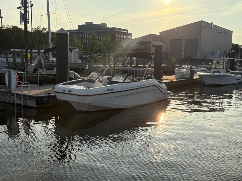 Slide: The Image of 2022 Bayliner DX 2200 boat docked at marina during sunset. - 4