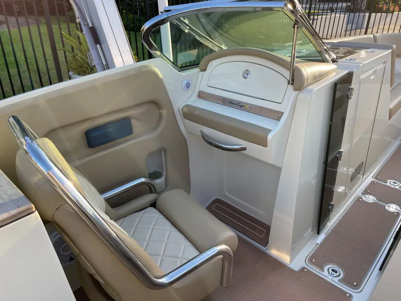 Slide: The Image of Luxurious interior of a 2015 Chris-Craft 32 Launch boat with beige seating and sleek design. - 10