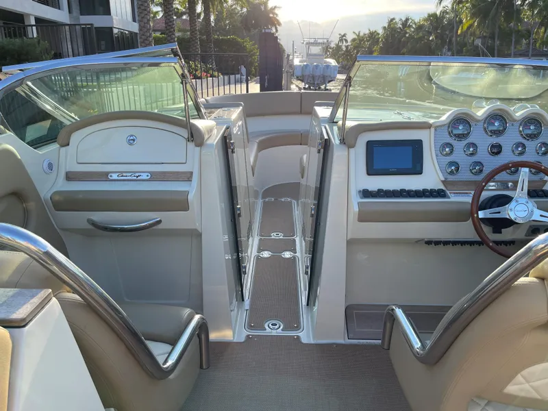 Slide: The Image of 2015 Chris-Craft 32 Launch boat interior with dual consoles and modern dashboard. - 11