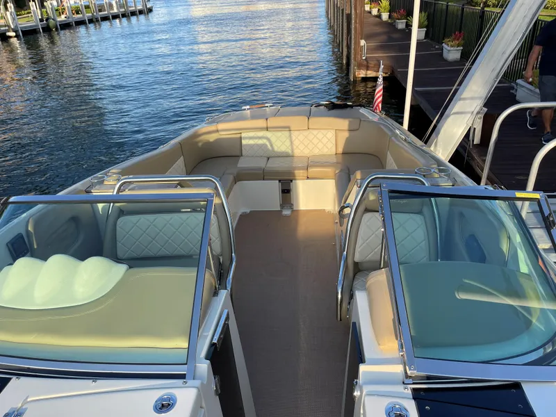 Slide: The Image of 2015 Chris-Craft 32 Launch boat with spacious seating, docked by the water. - 13