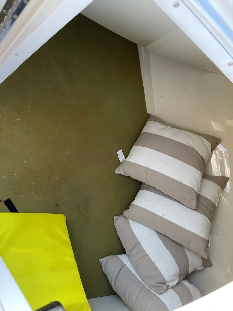 Slide: The Image of Interior cabin of 2015 Chris-Craft 32 Launch with striped cushions and yellow life jacket. - 14