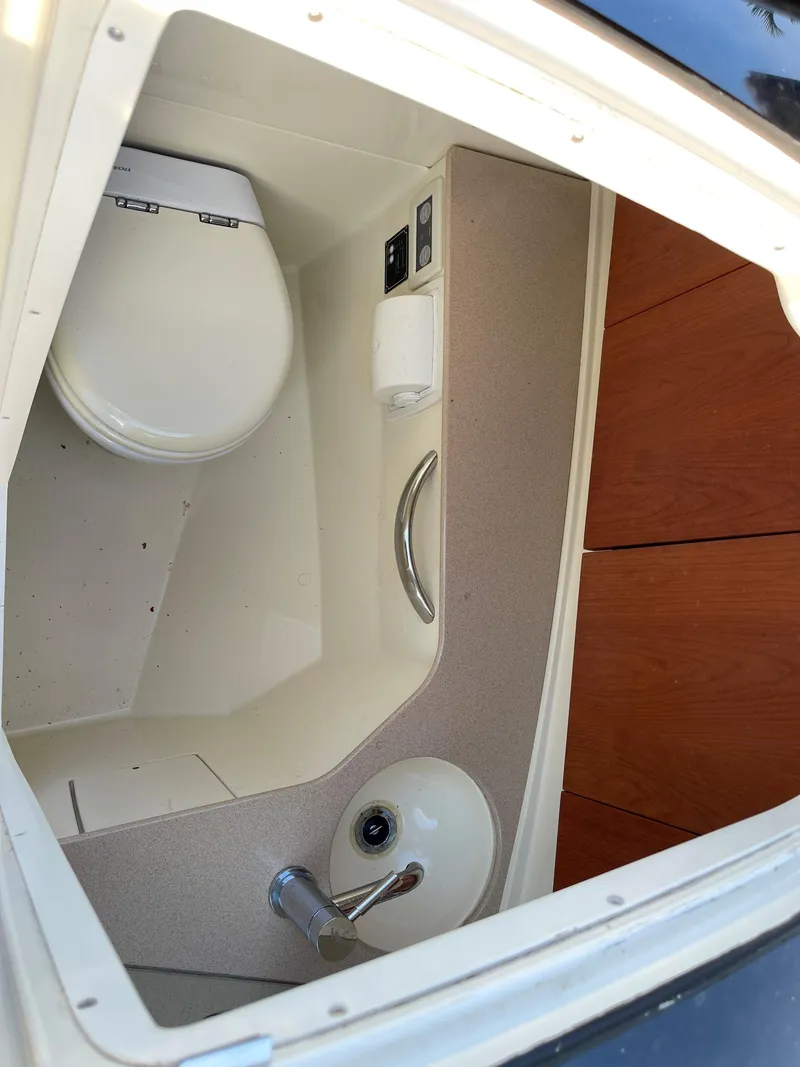 Slide: The Image of 2015 Chris-Craft 32 Launch boat interior bathroom with toilet and sink. - 15
