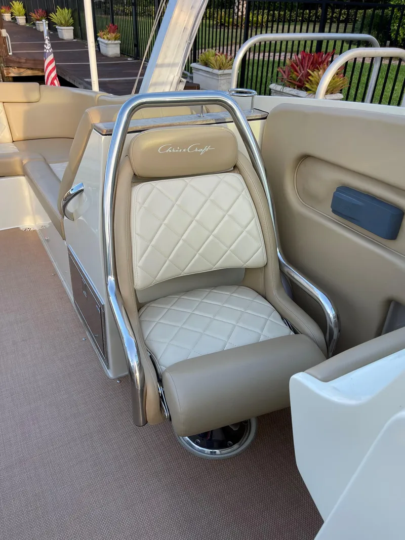 Slide: The Image of 2015 Chris-Craft 32 Launch boat seat with beige and white diamond-pattern upholstery. - 16