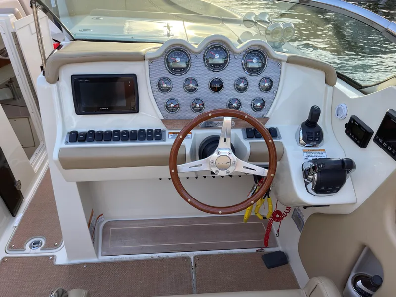 Slide: The Image of 2015 Chris-Craft 32 Launch boat dashboard with steering wheel and control panel. - 18