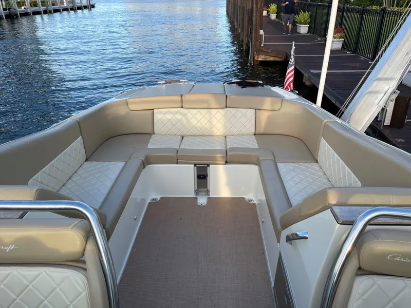 Slide: The Image of 2015 Chris-Craft 32 Launch boat with elegant seating, docked by calm waters. - 19