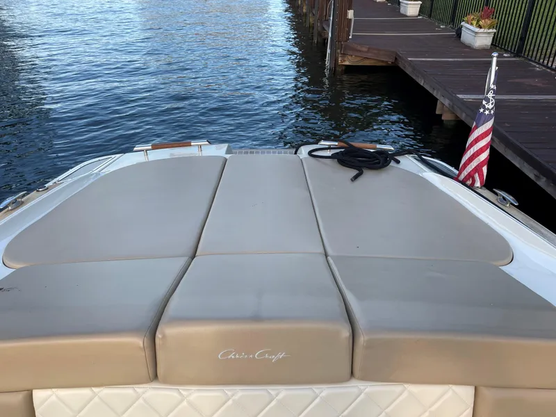 Slide: The Image of 2015 Chris-Craft 32 Launch boat at dock with American flag. - 23
