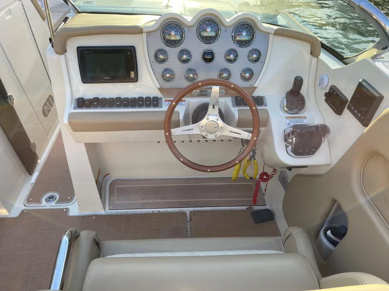 Slide: The Image of 2015 Chris-Craft 32 Launch dashboard with wood steering wheel and modern controls. - 9