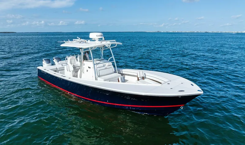 The Image of 2012 Regulator 32 FS boat on open water, featuring sleek design and spacious deck. - 1