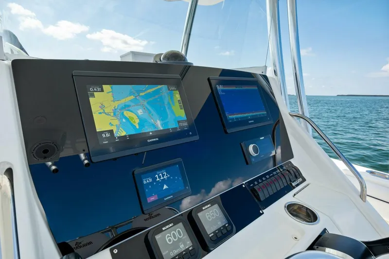 Slide: The Image of Control panel of a 2012 Regulator 32 FS boat with navigation screens. - 10