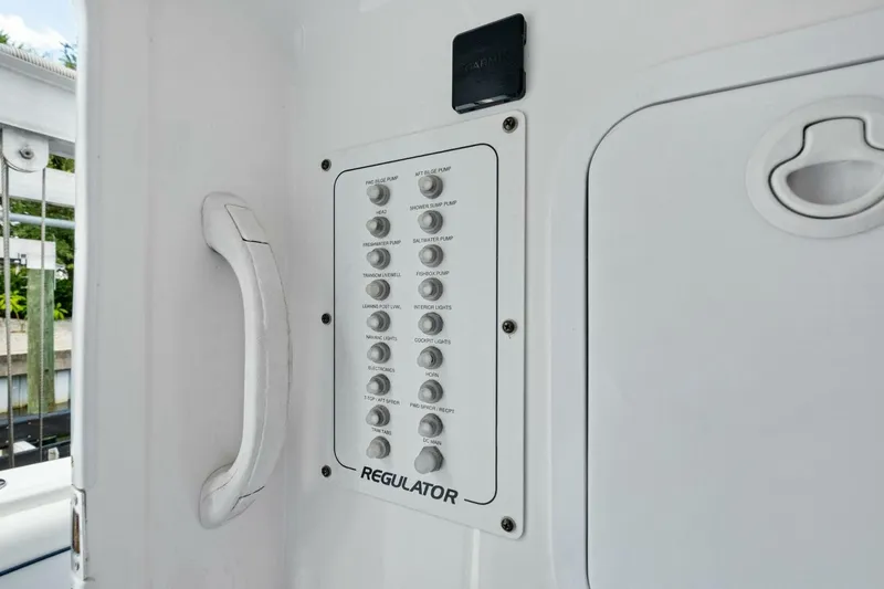 Slide: The Image of Control panel on a 2012 Regulator 32 FS boat, featuring various switches. - 14