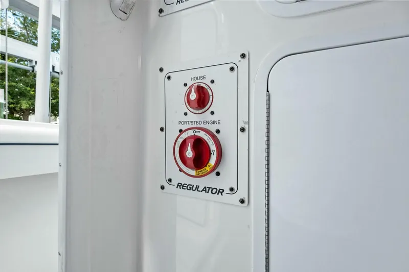 Slide: The Image of Control panel on a 2012 Regulator 32 FS boat with red switches. - 15